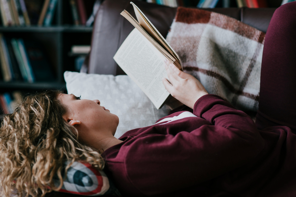 Person reading a book in warm light